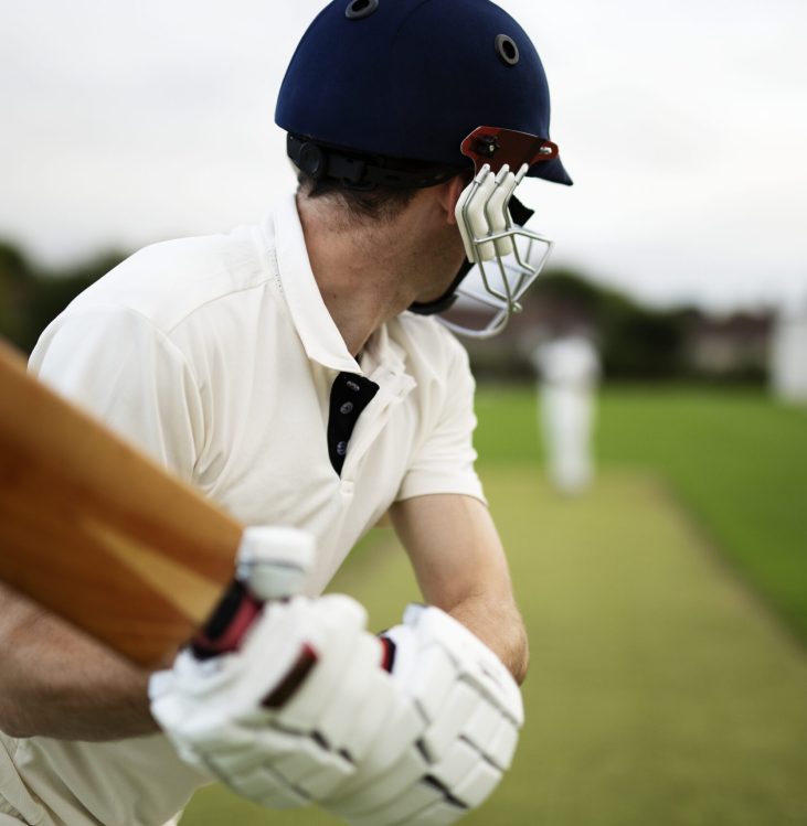 Cricketer on the field in action Cricketer on the field in action